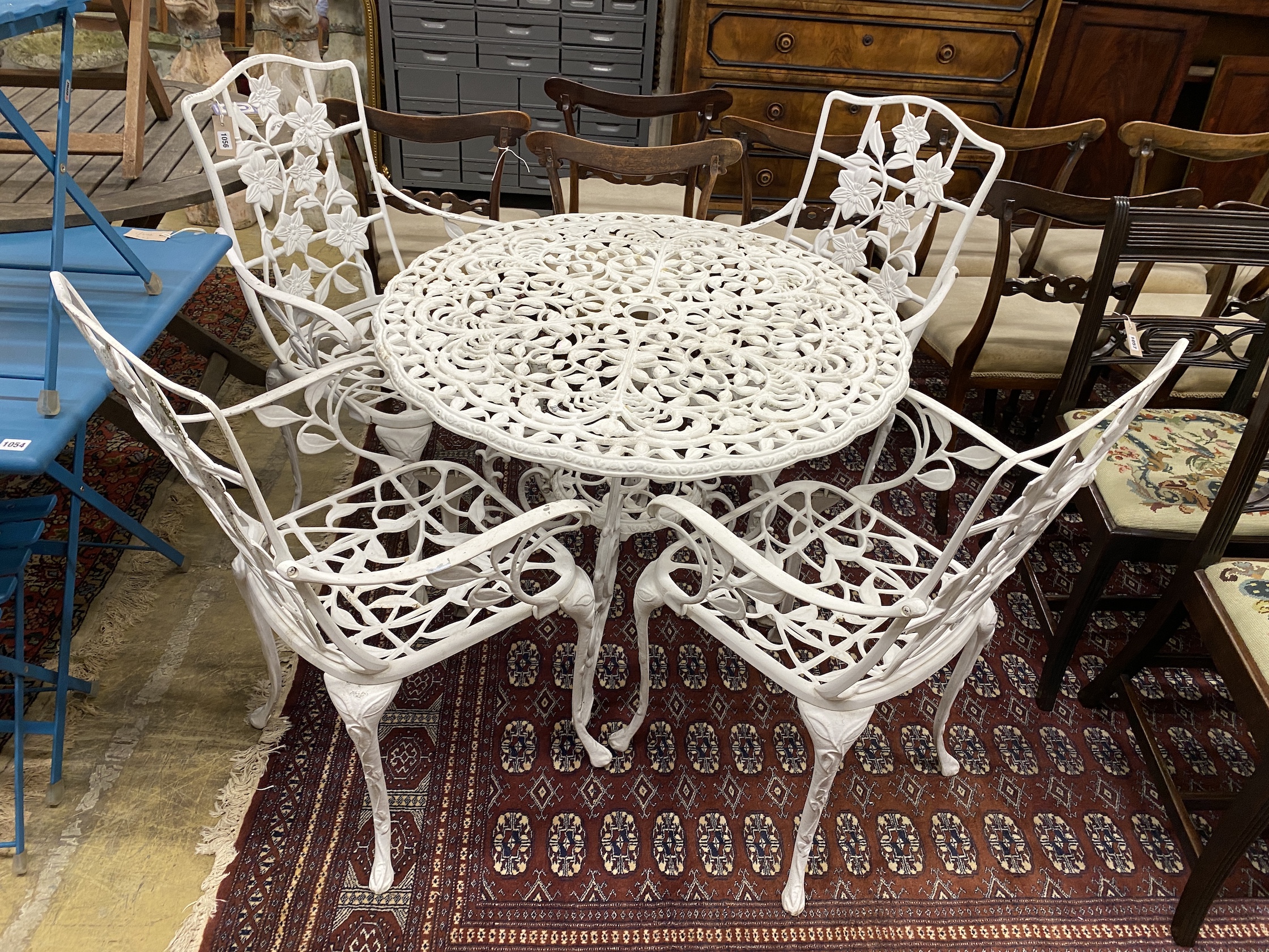 A Victorian style aluminium circular garden table, diameter 90cm, height 69cm and four chairs